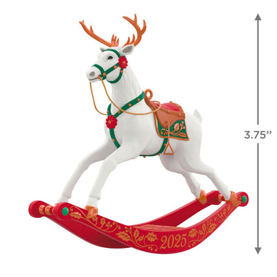 White reindeer Christmas ornament with bronze antlers and hooves, red flower accents, green bridle, on rocking stand

