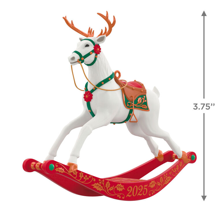 White reindeer Christmas ornament with bronze antlers and hooves, red flower accents, green bridle, on rocking stand

