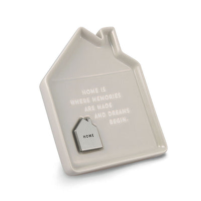 Taupe ceramic house-shaped trinket dish with debossed home message and removable engraved metal token.
