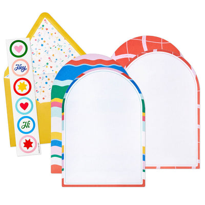 Stationery set with arched sheets in colorful wave and coral prints, yellow envelopes, and heart and star seal stickers.
