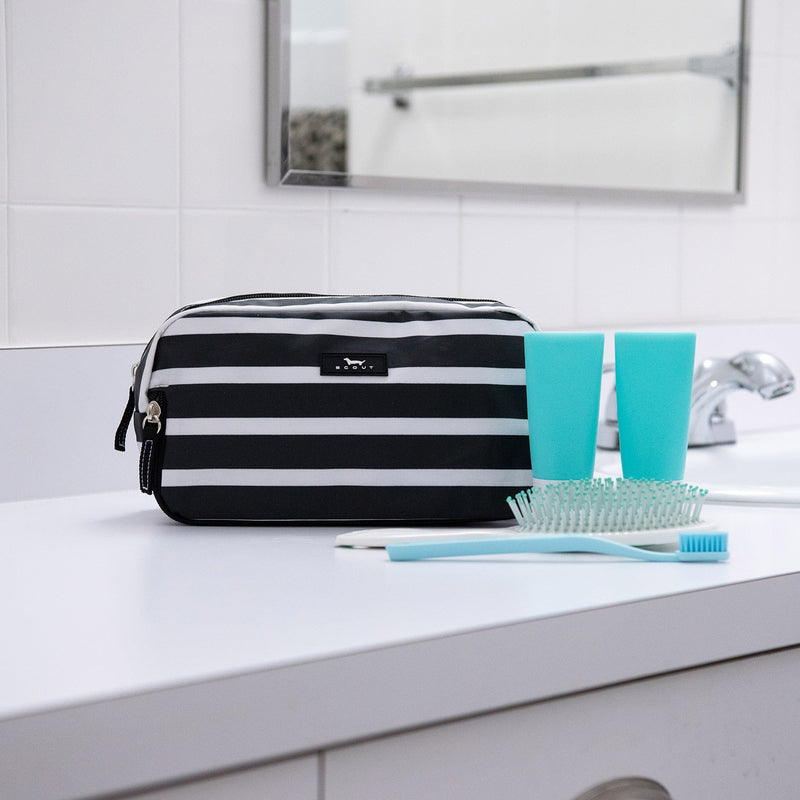 Late Bloomer 3-Zip toiletry bag with three compartments for organizing toiletries, makeup, or school supplies; stands upright.