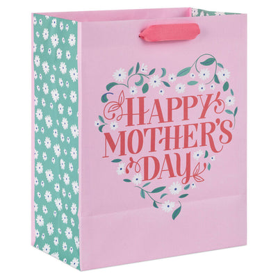 Hallmark medium pink gift bag with floral heart design, green vine, white flowers, and Happy Mother's Day message in red