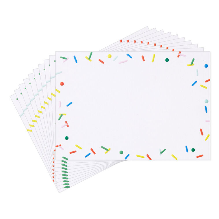 White flat note cards with colorful confetti sprinkle border design, bundled in kraft paper wrap.
