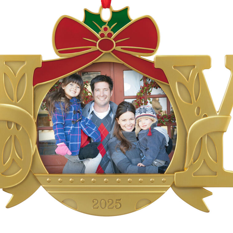 Gold JOY word-art photo frame ornament with red bow and holly topper, features 2025 date and holds a small holiday photo.