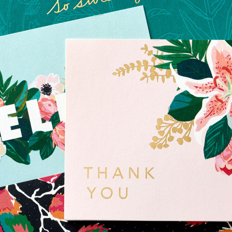 Boxed floral note card set featuring four unique designs with gold foil accents, includes 40 cards and envelopes.
