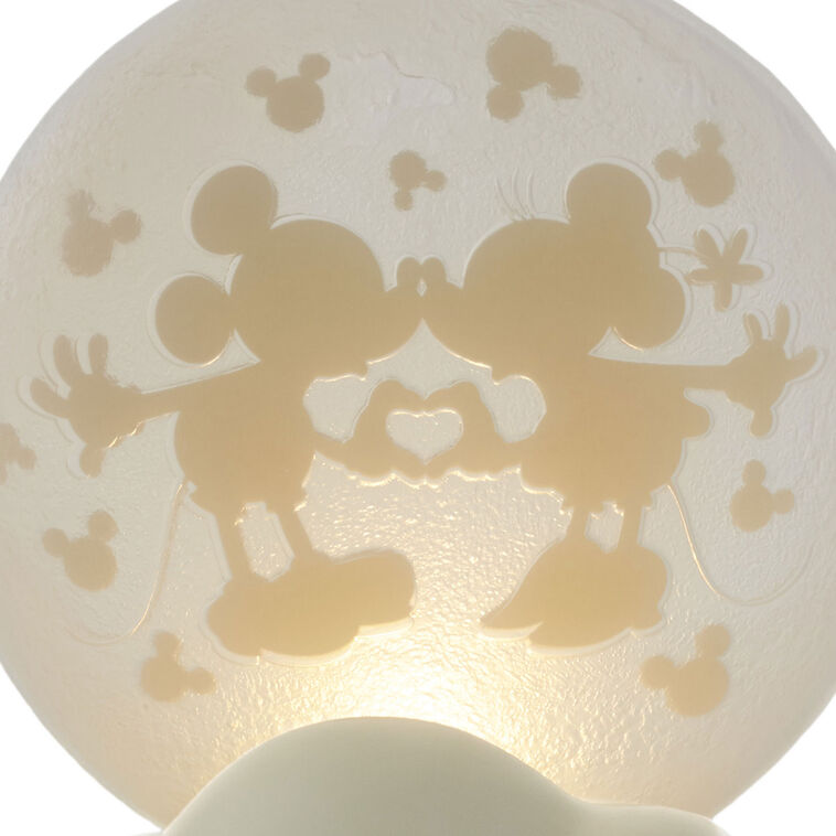 Light-up Mickey and Minnie figurine with heart hands silhouette on a frosted moon and “Over the moon” quote on the base.