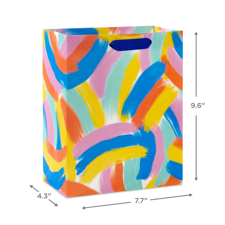 Hallmark medium gift bag with colorful abstract brushstroke rainbows in purple, blue, yellow, and orange on a white background