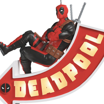 Deadpool ornament, Marvel character in red and black suit, arrow sign marquee, Hallmark Keepsake, Christmas decoration, light-up feature.