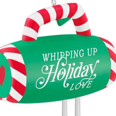 Green hand-mixer Christmas ornament with candy cane stripes and heart-shaped beaters, festive holiday kitchen decor


