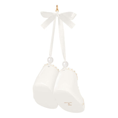 White porcelain baby booties ornament with 14K gold accents and satin ribbon bow, marked for baby’s 1st Christmas 2025.