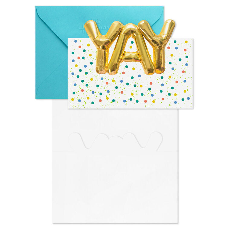 White note cards with gold balloon-style “YAY” lettering, confetti dots, and die-cut front, packaged in kraft wrap.
