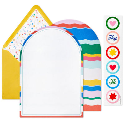 Stationery set with arched sheets in colorful wave and coral prints, yellow envelopes, and heart and star seal stickers.
