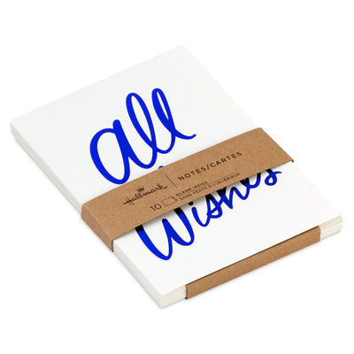 White note cards with vivid blue foil script reading “All the Wishes,” bundled in kraft paper wrap.
