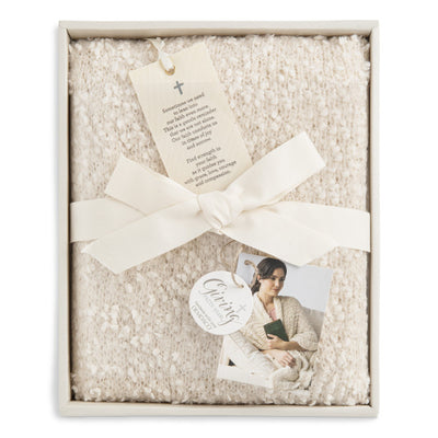 Ivory-colored soft giving shawl with a knitted texture, packaged for gifting, designed to provide comfort and warmth.