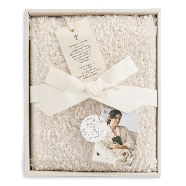 Ivory-colored soft giving shawl with a knitted texture, packaged for gifting, designed to provide comfort and warmth.