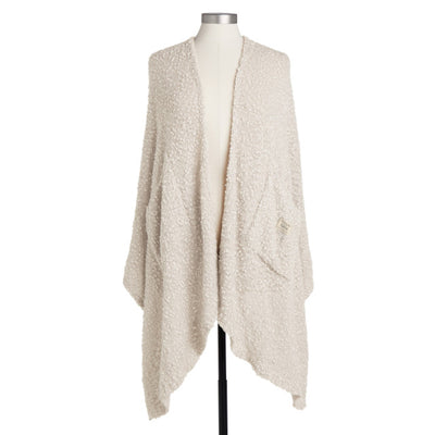 Ivory-colored soft giving shawl with a knitted texture, packaged for gifting, designed to provide comfort and warmth.