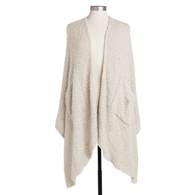 Ivory-colored soft giving shawl with a knitted texture, packaged for gifting, designed to provide comfort and warmth.