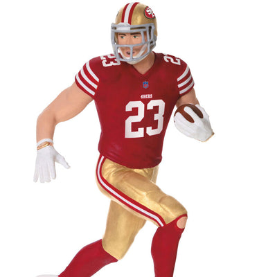 Christian McCaffrey ornament in 49ers red and gold uniform, number 23, action pose with football, Hallmark NFL Christmas collectible