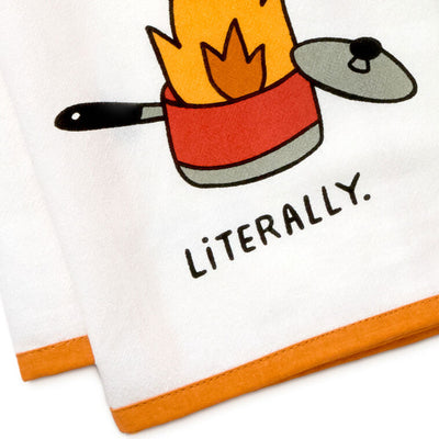 White cotton tea towel with orange border, featuring a flaming pot illustration and the message: “My cooking is fire.