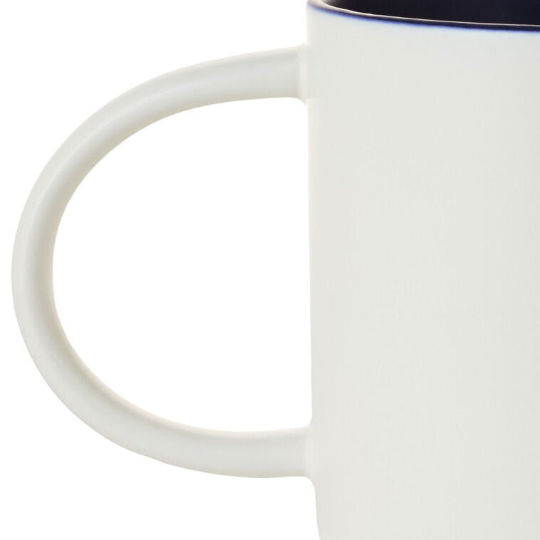 White ceramic mug with colorful "Every day is a Dadventure" lettering, oversized handle, and recessed base for stacking