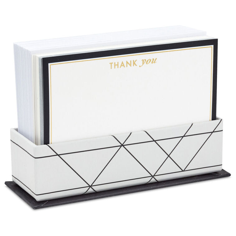 Blank flat note cards with gold lettering and black borders, includes envelopes and white caddy with black geometric lines.