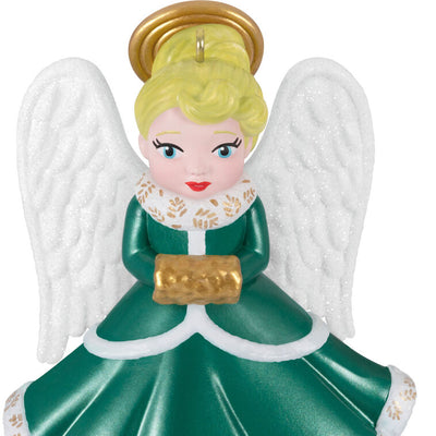 Hallmark Keepsake ornament of blonde angel in green and white dress with gold trim, glittery wings, and gold muff