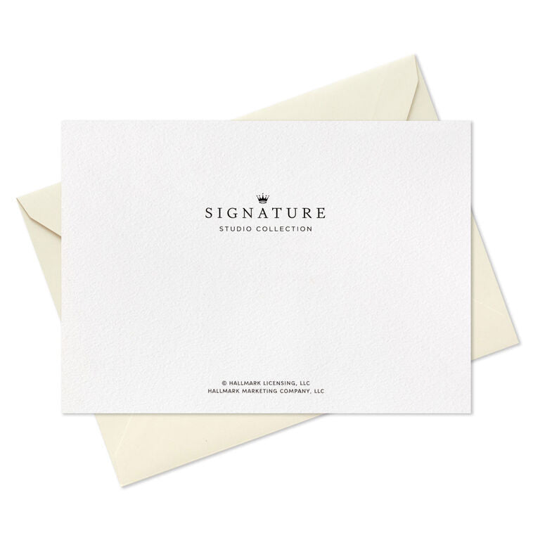 Blush pink thank-you cards with gold foil “Merci” script lettering and matching foil-lined envelopes in a white display box.
