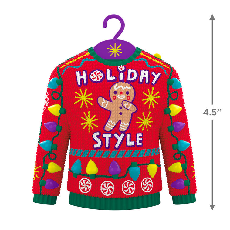 Red and green Christmas sweater ornament with gingerbread man, candy, and lights, plays "Carol of the Bells."

