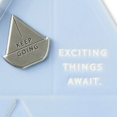 Light blue sailboat-shaped Hallmark trinket dish with removable “Keep going” token and inspiring message.