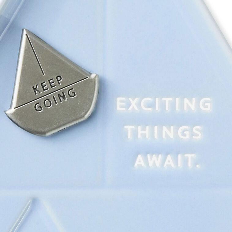 Light blue sailboat-shaped Hallmark trinket dish with removable “Keep going” token and inspiring message.