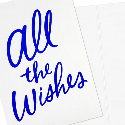 White note cards with vivid blue foil script reading “All the Wishes,” bundled in kraft paper wrap.
