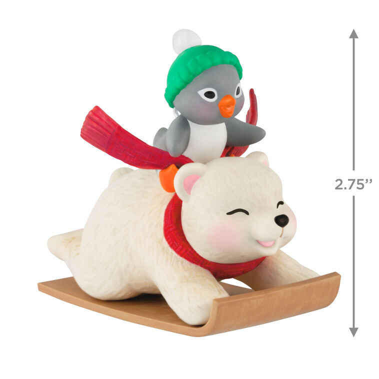 Tuxedo penguin in green hat rides Snowball the polar bear on toboggan, Hallmark Keepsake Christmas ornament