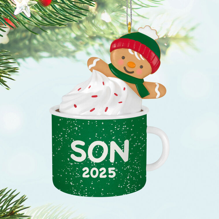 2025 Christmas ornament of gingerbread son cookie in green mug with whipped cream, festive holiday design

