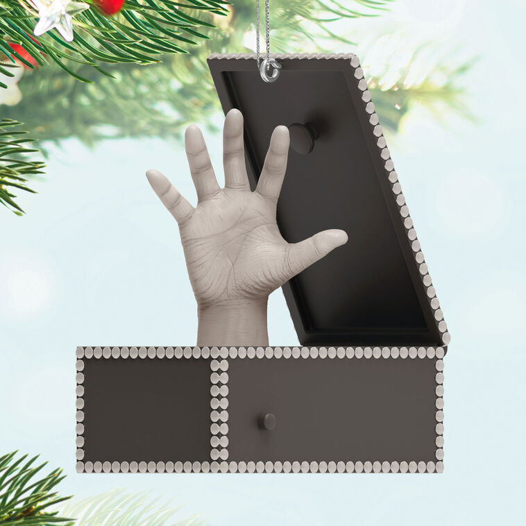 Musical ornament of Thing hand in box from The Addams Family TV show, plays theme song when button is pressed