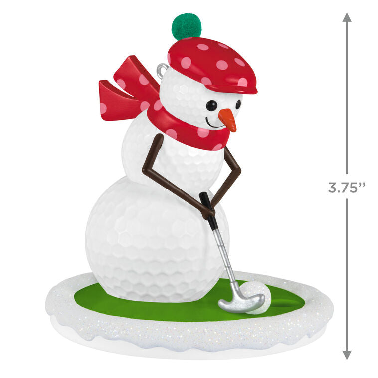 Golf ball snowman ornament in red polka dot hat and scarf, hitting a snowball with a silver putter

