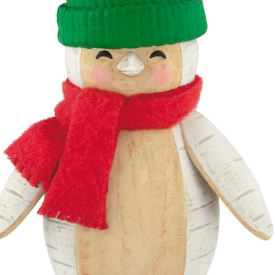 Penguin Christmas ornament styled like birch wood, wearing red scarf and green stocking hat