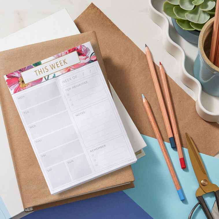 Floral weekly planner pad with gold foil accents and tear-off sheets for notes and scheduling.