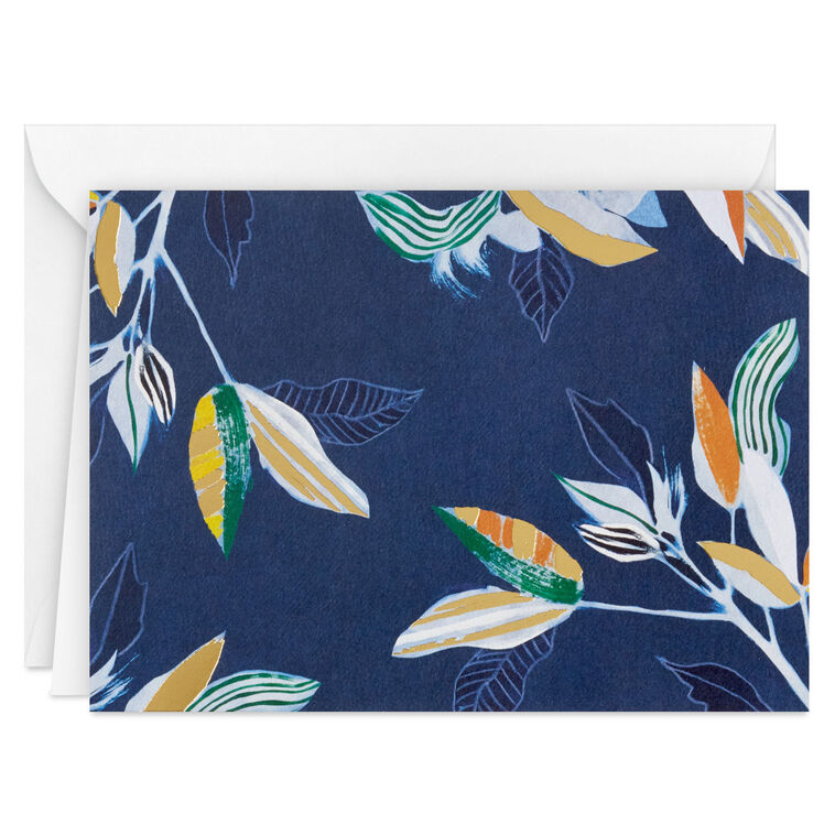 Elegant blank note cards with gold-accented tropical leaves on navy background, boxed set of 10 with white envelopes.
