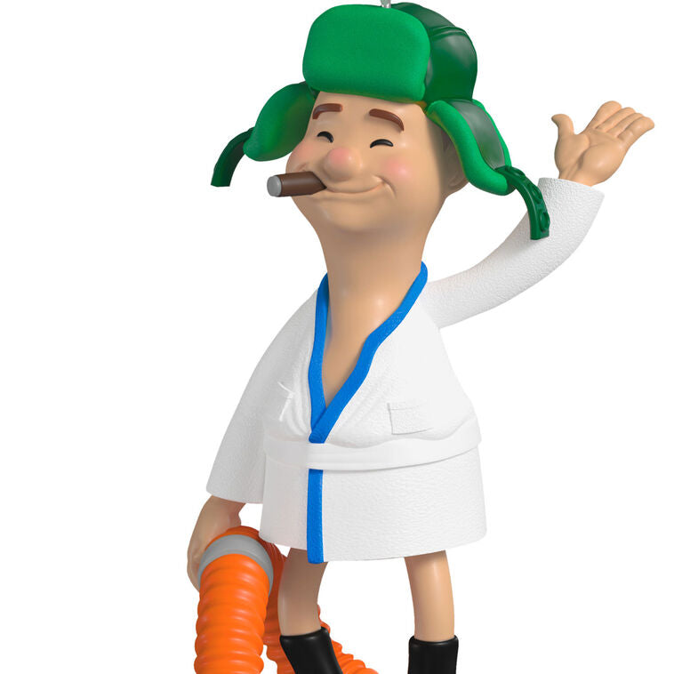 Cousin Eddie ornament from Hallmark Keepsake, wearing a bathrobe and trapper hat, standing next to an RV toilet from National Lampoon&