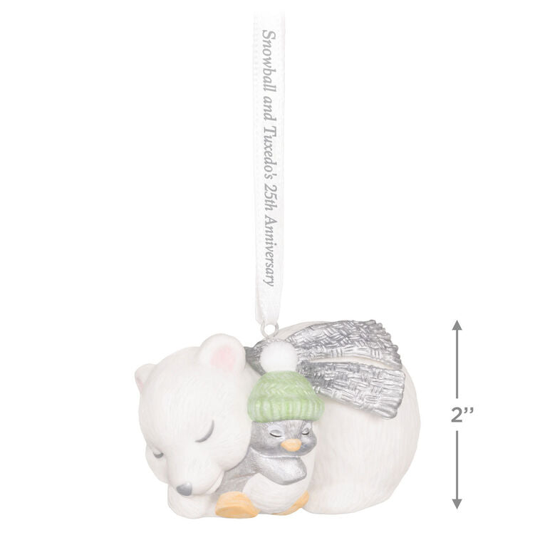 Hallmark Keepsake ornament of Snowball the polar bear cuddling Tuxedo the penguin, white and silver design celebrating 25th anniversary.