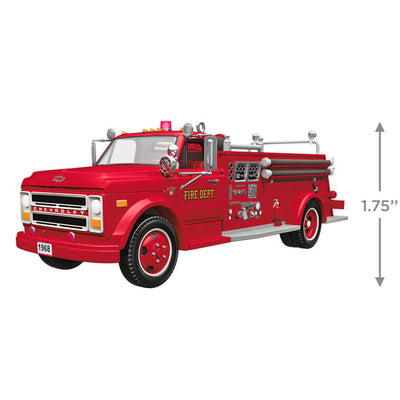 1968 red Chevrolet fire engine Christmas ornament with ladder details, turning wheels, and battery-powered light on front grill.