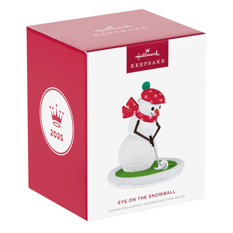 Golf ball snowman ornament in red polka dot hat and scarf, hitting a snowball with a silver putter

