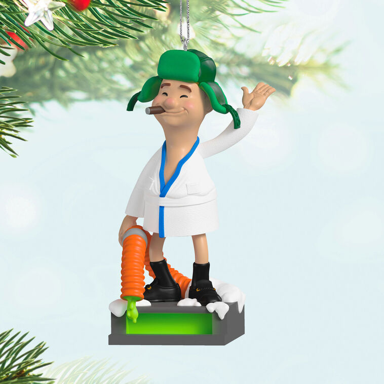 Cousin Eddie ornament from Hallmark Keepsake, wearing a bathrobe and trapper hat, standing next to an RV toilet from National Lampoon&
