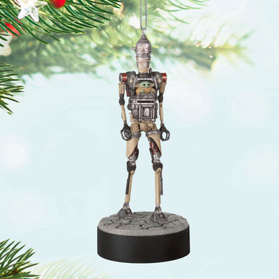 Ornament of Grogu piloting IG-12 droid from Star Wars: The Mandalorian™, on round base with sound button for “Yes” and “No” phrases.