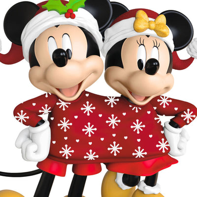 Mickey and Minnie wearing Santa hats and sharing a red Christmas sweater with snowflakes and hearts, Disney ornament.

