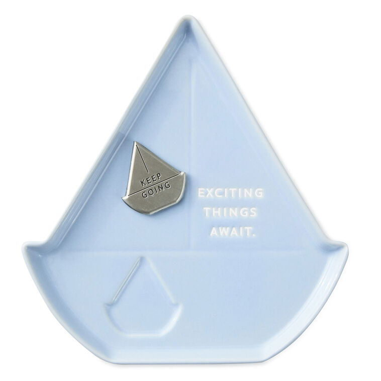 Light blue sailboat-shaped Hallmark trinket dish with removable “Keep going” token and inspiring message.