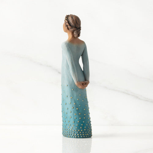 Willow Tree Radiance figurine with darker skin in a deep blue ombré dress dotted with gold leaf.