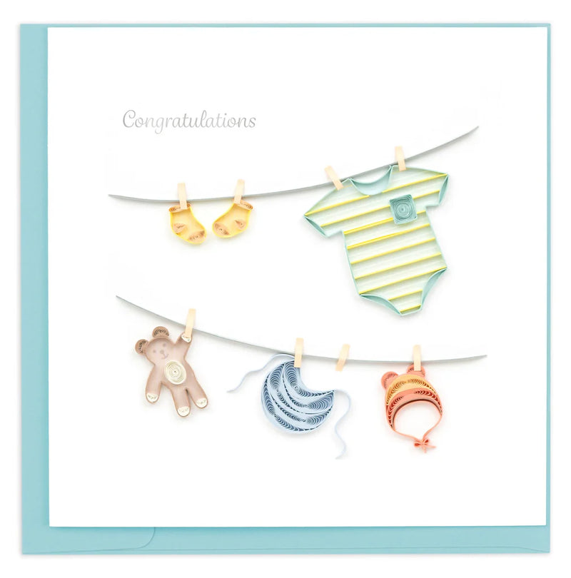 Quilled baby card with onesies, bibs, and hats hanging from a clothesline. A handmade card perfect for welcoming a newborn.