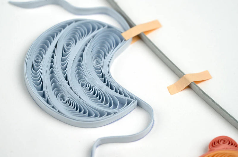 Quilled baby card with onesies, bibs, and hats hanging from a clothesline. A handmade card perfect for welcoming a newborn.