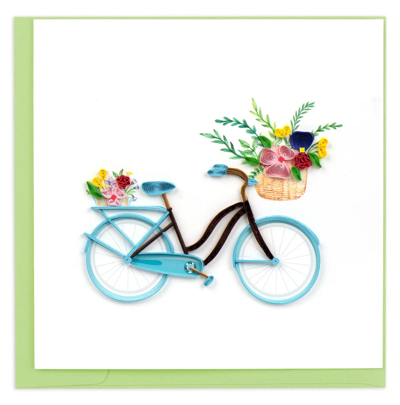 Hand-quilled greeting card featuring a blue bicycle with a flower-filled basket and green border, perfect for cheerful occasions.